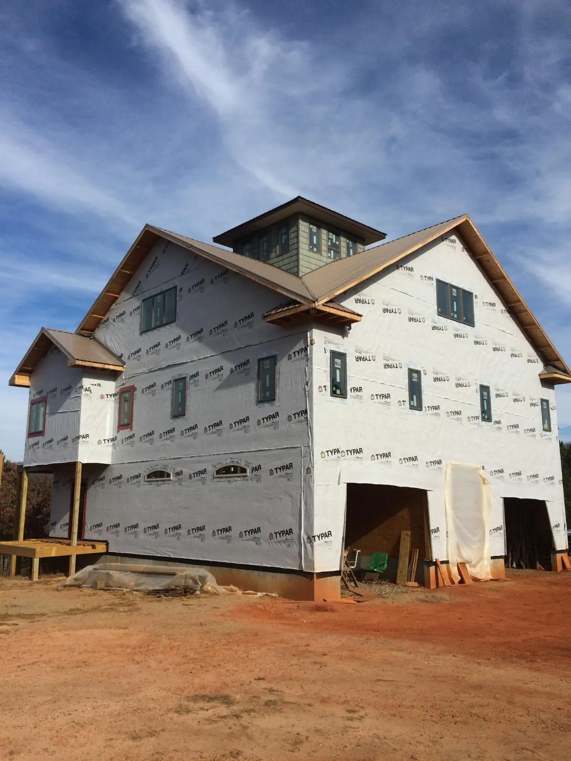 New two story house under construction with a cupola and gabled roofs in Cliffside